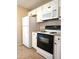 Kitchen appliances with white cabinets, granite countertops, and black hardware at 9218 40Th N Way, Pinellas Park, FL 33782