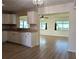 Kitchen with white cabinets, granite counters, and an open view to the living room at 9218 40Th N Way, Pinellas Park, FL 33782