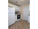 Bright kitchen featuring white cabinets and appliances with granite countertops at 9218 40Th N Way, Pinellas Park, FL 33782