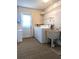 Functional laundry room with washer, dryer, utility sink, and storage shelves at 9218 40Th N Way, Pinellas Park, FL 33782