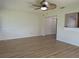 Living room with wood floors, a stylish ceiling fan and decorative wall paneling at 9218 40Th N Way, Pinellas Park, FL 33782