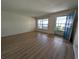 Bright living room with light wood flooring, a large window and a blue front door at 9218 40Th N Way, Pinellas Park, FL 33782