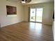 Living room with wood floors, sliding glass door to the yard, and ceiling fan at 9218 40Th N Way, Pinellas Park, FL 33782