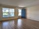 Inviting living room with light wood flooring, a large window, and a blue front door at 9218 40Th N Way, Pinellas Park, FL 33782