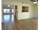Open floor plan with living room and kitchen, featuring wood floors and ample lighting at 9218 40Th N Way, Pinellas Park, FL 33782