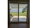 View through glass patio doors to the green lawn and lanai in the backyard at 9218 40Th N Way, Pinellas Park, FL 33782