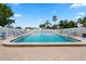 Refreshing pool with ample seating, surrounded by manicured landscaping and white fencing at 9218 40Th N Way, Pinellas Park, FL 33782