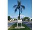Palm tree with the sign for Mainlands Unit 5, set against a clear blue sky at 9218 40Th N Way, Pinellas Park, FL 33782