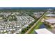 Aerial view of the mobile home community including a railway, lake, and industrial building nearby at 9790 66Th N St # 353, Pinellas Park, FL 33782