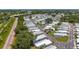 Extensive aerial shot featuring a well-organized mobile home community with lush trees, railroad tracks, and a highway nearby at 9790 66Th N St # 353, Pinellas Park, FL 33782