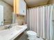 A well-lit bathroom featuring a single sink vanity, toilet, and shower-tub combination at 9790 66Th N St # 353, Pinellas Park, FL 33782