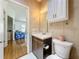 A well-lit bathroom featuring a single sink vanity, toilet, and overhead cabinet at 9790 66Th N St # 353, Pinellas Park, FL 33782