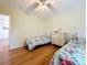 A bedroom featuring two twin beds, a dresser, and hardwood floors, creating a cozy and inviting space at 9790 66Th N St # 353, Pinellas Park, FL 33782