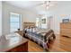 Bedroom boasts hardwood floors, a ceiling fan, natural light, and two dressers for storage at 9790 66Th N St # 353, Pinellas Park, FL 33782