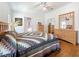 Bedroom boasts hardwood floors, a ceiling fan, and a large mirrored closet, with an ensuite bathroom at 9790 66Th N St # 353, Pinellas Park, FL 33782