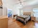 Spacious bedroom with hardwood floors, ceiling fan, and bright natural light at 9790 66Th N St # 353, Pinellas Park, FL 33782