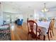 Bright dining room features hardwood floors, a ceiling fan and chandelier, and lots of natural light from several windows at 9790 66Th N St # 353, Pinellas Park, FL 33782