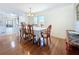 A bright dining room features hardwood floors, white walls, and a table set for six under a chandelier at 9790 66Th N St # 353, Pinellas Park, FL 33782