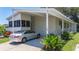 Exterior of the home featuring a carport and a well-maintained lawn at 9790 66Th N St # 353, Pinellas Park, FL 33782
