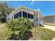 Exterior shot of home with carport and landscaping, highlighting the serene setting at 9790 66Th N St # 353, Pinellas Park, FL 33782