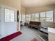 A Florida room featuring large windows, seating, and a front door that provides access to the outside at 9790 66Th N St # 353, Pinellas Park, FL 33782