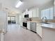 Bright kitchen with stainless steel appliances and a tiled floor, with an opening to an outdoor screened in porch at 9790 66Th N St # 353, Pinellas Park, FL 33782