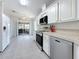 Bright kitchen with stainless steel appliances and a tiled floor, with an opening to an outdoor screened in porch at 9790 66Th N St # 353, Pinellas Park, FL 33782