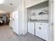 A laundry room equipped with a washer, dryer, and cabinetry, providing convenience for laundry tasks at 9790 66Th N St # 353, Pinellas Park, FL 33782