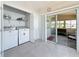 A laundry room with washer and dryer, sliding glass doors to Florida Room and access to the outdoors at 9790 66Th N St # 353, Pinellas Park, FL 33782