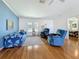 Well-lit living room with hardwood flooring, blue accent wall, and comfortable seating at 9790 66Th N St # 353, Pinellas Park, FL 33782