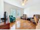 Spacious living room with two large windows, wood floors, and comfortable seating at 9790 66Th N St # 353, Pinellas Park, FL 33782