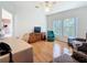 Living room with hardwood floors, a large desk and views of the outside trees from the large windows at 9790 66Th N St # 353, Pinellas Park, FL 33782
