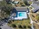 Aerial view of a community pool surrounded by lush landscaping and lounge chairs, perfect for relaxation at 9790 66Th N St # 353, Pinellas Park, FL 33782