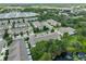 An aerial view showcases a peaceful community with homes surrounded by nature, offering serene lakeside views at 10132 Post Harvest Dr, Riverview, FL 33578