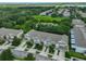 Aerial view of townhomes surrounded by water and trees at 10132 Post Harvest Dr, Riverview, FL 33578