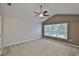 Bedroom with vaulted ceiling, ceiling fan, and large window allowing natural light at 10132 Post Harvest Dr, Riverview, FL 33578