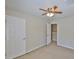 Carpeted bedroom featuring a ceiling fan and a closet entrance at 10132 Post Harvest Dr, Riverview, FL 33578