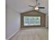 Bright bedroom with a vaulted ceiling, ceiling fan, and large window at 10132 Post Harvest Dr, Riverview, FL 33578