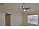 This bedroom offers neutral walls, carpet flooring, a ceiling fan, and an attached bathroom at 10132 Post Harvest Dr, Riverview, FL 33578