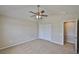 This bedroom features neutral walls, carpet flooring, a ceiling fan, and double closet at 10132 Post Harvest Dr, Riverview, FL 33578