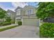Two-story townhome with a well-maintained lawn, a two-car garage, and lush landscaping in a lovely neighborhood at 10132 Post Harvest Dr, Riverview, FL 33578