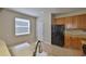 Kitchen features wooden cabinets, neutral countertops, and black appliances at 10132 Post Harvest Dr, Riverview, FL 33578
