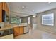 Open kitchen with breakfast bar, stainless steel dishwasher, and view to the living room at 10132 Post Harvest Dr, Riverview, FL 33578