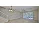 Living room with neutral carpet, staircase, chandelier and sliding glass door at 10132 Post Harvest Dr, Riverview, FL 33578