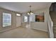 Bright living room with open dining and kitchen, featuring neutral carpet and a staircase at 10132 Post Harvest Dr, Riverview, FL 33578