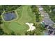 An aerial view of home's backyard with a pool and golf course beyond the property line, highlighting a backyard oasis at 10559 Coral Key Ave, Tampa, FL 33647