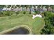 A high angle aerial of a pristine golf course neighborhood with sand traps and ponds at 10559 Coral Key Ave, Tampa, FL 33647