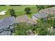 Aerial view showcasing the house, surrounding trees, and golf course at 10559 Coral Key Ave, Tampa, FL 33647