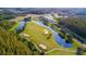 Scenic aerial view of the golf course featuring lush green fairways, tranquil water features, and impeccably manicured sand traps at 10559 Coral Key Ave, Tampa, FL 33647