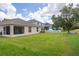 Backyard view with a lawn, fence, and screened porch of the house at 10559 Coral Key Ave, Tampa, FL 33647